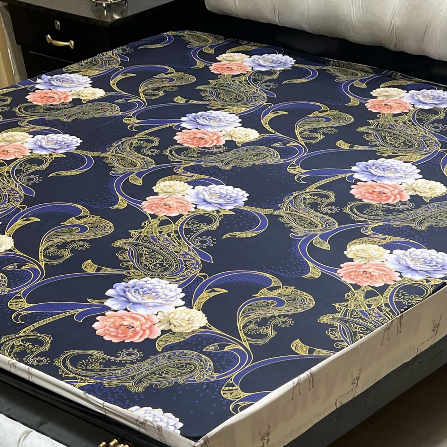 Printed floral waterproof mattress cover queen size with fitted elastic spread neatly on a luxury bed.