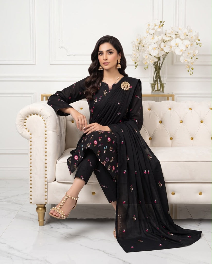 Model wearing a classic black premium Airjet Dhanak unstitched suit with vibrant floral embroidery from Aneela's Winter Collection.