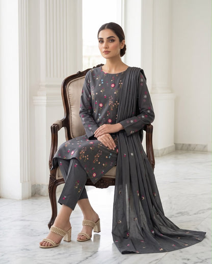 Model wearing a classic black premium Airjet Dhanak unstitched suit with vibrant floral embroidery from Aneela's Winter Collection.