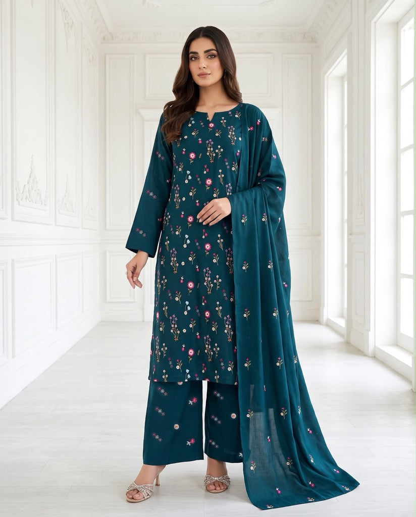 A model wearing Aneela's Winter Collection Deep Teal premium Airjet Dhanak unstitched suit featuring delicate pink floral embroidery and a matching shawl.