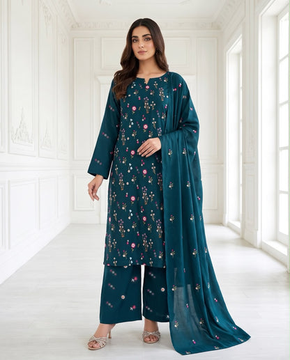 A model wearing Aneela's Winter Collection Deep Teal premium Airjet Dhanak unstitched suit featuring delicate pink floral embroidery and a matching shawl.