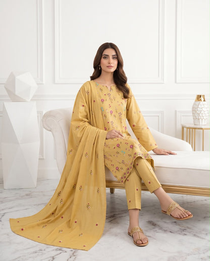 Mustard yellow premium Airjet Dhanak unstitched suit with vibrant floral embroidery from Aneela's Winter Collection, worn by a model.