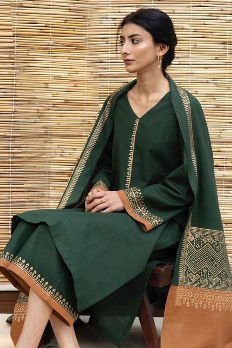 Model wearing a forest green Dyot Dhanak 3pc suit with rust borders from our winter collection sale on brands.