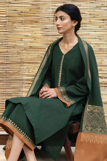 Model wearing a forest green Dyot Dhanak 3pc suit with rust borders from our winter collection sale on brands.
