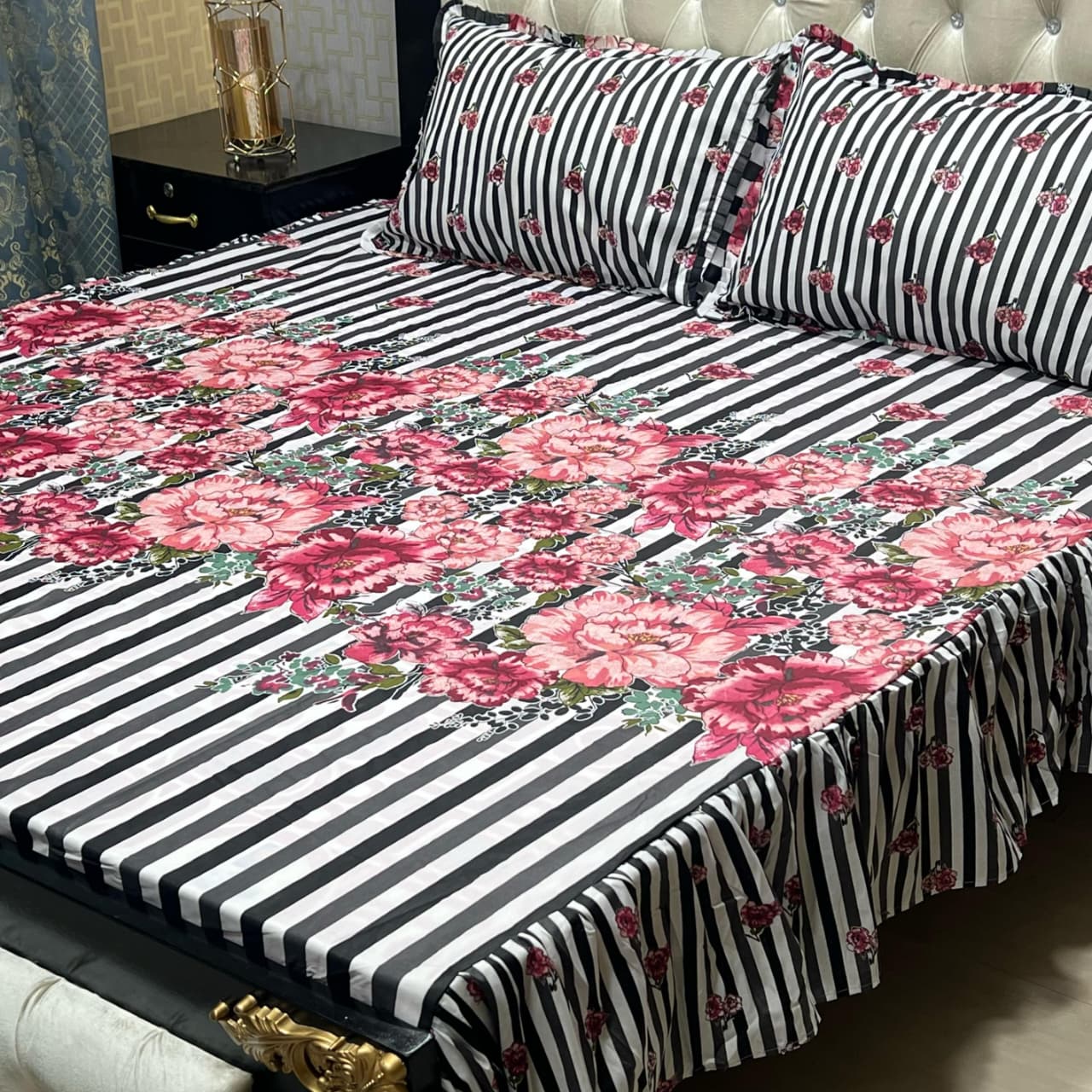 Floral and stripe printed frill bedsheet king size with matching pillow covers on a bed