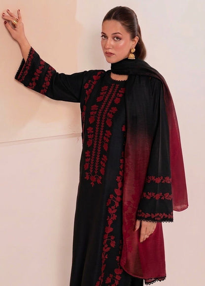Close-up of striking red floral embroidery on the front and sleeves of the black Airjet Dhanak fabric.