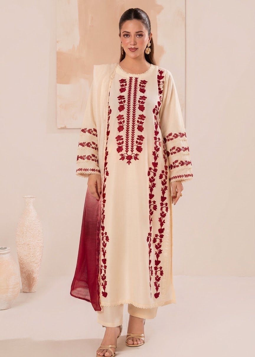 Model wearing an elegant off-white Laam Dhanak 3pc suit with heavy red embroidery from the Laam sale winter collection.